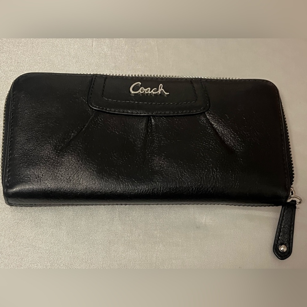 Authentic Coach Black Leather Accordion Wallet with a rich purple fabric lining.